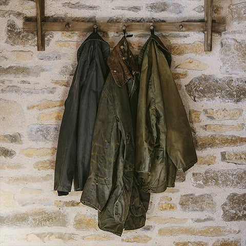 Barbour Wax Jackets hanging up on a coathanger.