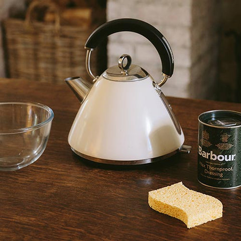 A Bowl, a jettle, a sponge and Barbour Wax Thornproof Dressing jar